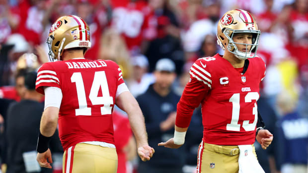 Dec 17, 2023; Glendale, Arizona, USA; San Francisco 49ers quarterback Brock Purdy (13) greets quarterback Sam Darnold (14) as he comes back into the game after an injury during the first half against the Arizona Cardinals at State Farm Stadium. Mandatory Credit: Mark J. Rebilas-USA TODAY Sports
