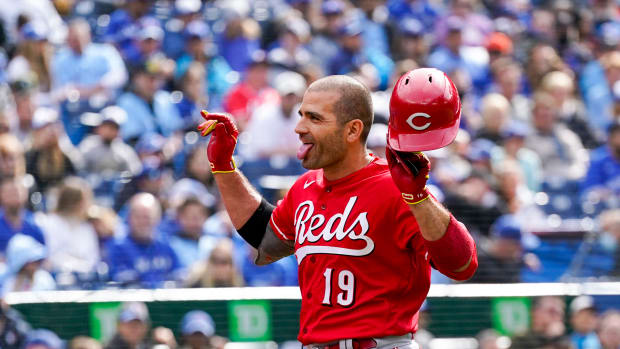 May 22, 2022; Toronto, Ontario, CAN; Cincinnati Reds first baseman Joey Votto (19) celebrates with teammate shortstop Kyle Farmer (17) after hitting a solo home run during the eighth inning against the Toronto Blue Jays at Rogers Centre.