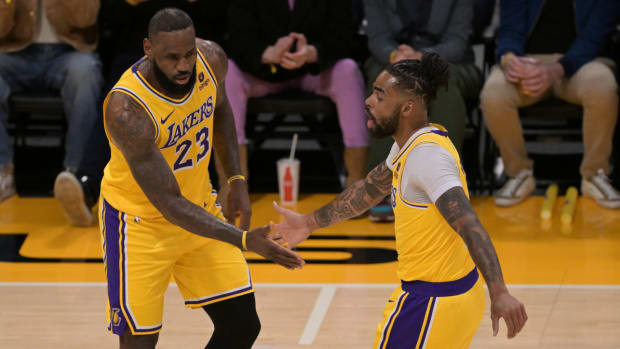 LeBron James high-fives Los Angeles Lakers teammate D’Angelo Russell.