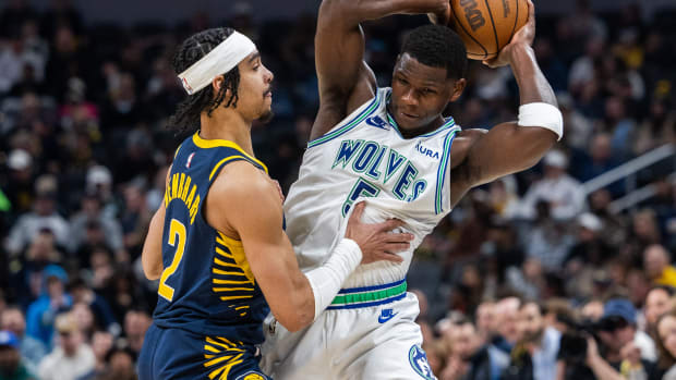 Minnesota Timberwolves guard Anthony Edwards (5) holds the ball while Indiana Pacers guard Andrew Nembhard (2) defends during the first half at Gainbridge Fieldhouse in Indianapolis on March 7, 2024.