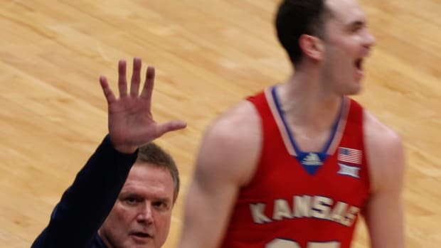 Kansas Jayhawks Head Coach Bill Self gestures to the parents of guard Nicolas Timberlake after a made basket during a game against the Kansas State Wildcats.