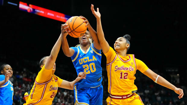 UCLA Bruins guard Charisma Osborne (20) battles against USC Trojans forward Kaitlyn Davis (24) and USC Trojans guard JuJu Watkins