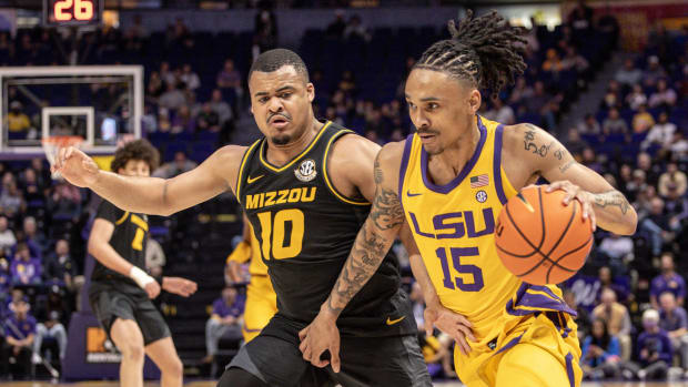 Mar 9, 2024; Baton Rouge, Louisiana, USA; LSU Tigers forward Tyrell Ward (15) brings the ball up court against Missouri Tigers guard Nick Honor (10) during the first half at Pete Maravich Assembly Center