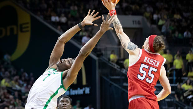 Utah guard Gabe Madsen snags a pass from Oregon center N'Faly Dante as the Oregon Ducks host the Utah Utes Saturday, March 9, 2024 at Matthew Knight Arena in Eugene, Ore.