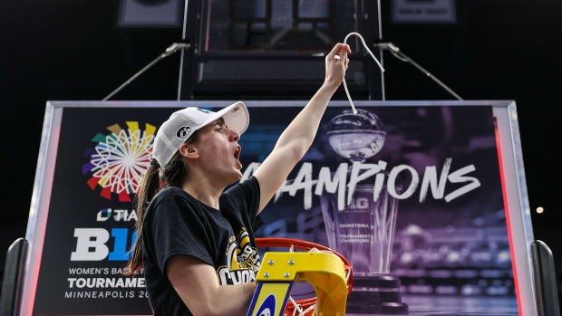 Iowa's Caitlin Clark (22) cuts a piece off the net after the game against the Nebraska Cornhuskers at Target Center on March 10, 2024 in Minneapolis. (Matt Krohn/USA TODAY Sports)