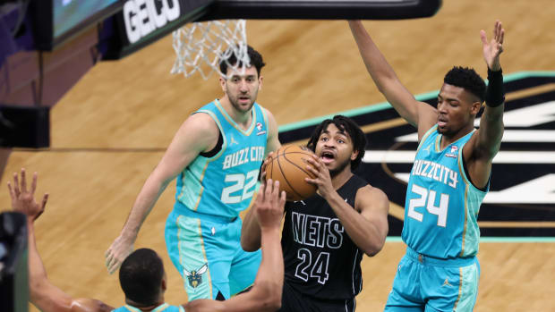  Brooklyn Nets guard Cam Thomas (24) go ups for a layup against Charlotte Hornets forward Brandon Miller (24) during the second quarter at Spectrum Center.