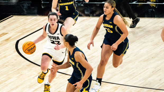 Michigan guard Laila Phelia (5) drives to the basket against Iowa guard Caitlin Clark (22) during the Big Ten Tournament semifinals at the Target Center on Saturday, March 9, 2024, in Minneapolis, Minn.