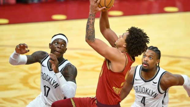 Mar 10, 2024; Cleveland, Ohio, USA; Cleveland Cavaliers guard Craig Porter Jr. (9) drives to the basket between Brooklyn Nets guard Dennis Schroder (17) and guard Dennis Smith Jr. (4) in the third quarter at Rocket Mortgage FieldHouse.