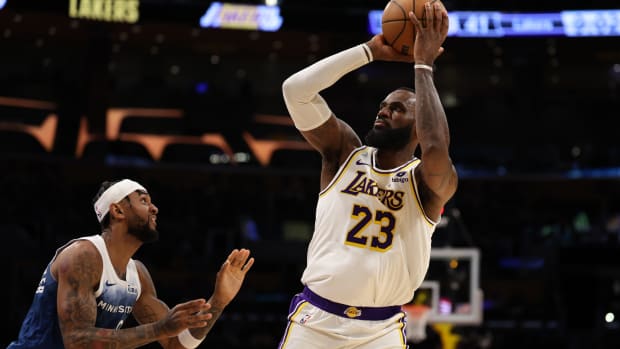 Mar 10, 2024; Los Angeles, California, USA; Los Angeles Lakers forward LeBron James (23) shoots the ball over Minnesota Timberwolves guard Nickeil Alexander-Walker (9) during the second quarter at Crypto.com Arena.