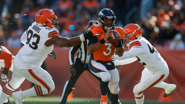 Nov 26, 2023; Denver, Colorado, USA; Denver Broncos quarterback Russell Wilson (3) looks to pass under pressure from Cleveland Browns defensive tackle Shelby Harris (93) an dlinebacker Tony Fields II (42) in the first quarter at Empower Field at Mile High. Mandatory Credit: Isaiah J. Downing-USA TODAY Sports