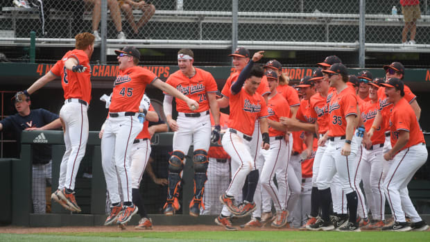 Casey Saucke celebrates with his teammates after hitting a home run during the Virginia baseball game against Miami in Coral Gables.