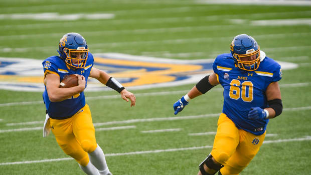 South Dakota State's Mark Gronowski runs with the ball alongside Mason McCormick during the FCS semifinals against Delaware on Saturday, May 8, 2021 at Dana J. Dykhouse stadium in Brookings. Sdsu Semifinals 020