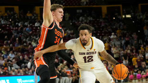Arizona State guard Jose Perez (12) is defended by Oregon State forward Tyler Bilodeau (34) during the second half at Desert Financial Arena in Tempe on Feb. 14, 2024.