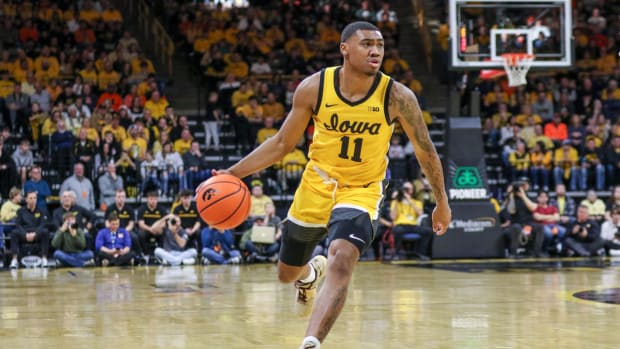 Iowa's Tony Perkins (11) looks for an open teammate during a game against Illinois on March 10, 2024 at Carver-Hawkeye Arena in Iowa City, Iowa. (Rob Howe/HN)