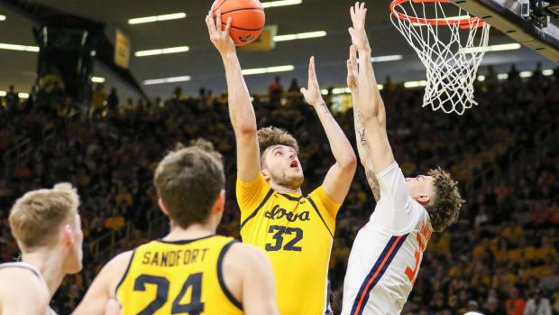 Iowa's Owen Freeman (32) shoots over Illinois' Coleman Hawkins (13) on March 10, 2024 at Carver-Hawkeye Arena in Iowa City, Iowa. (Rob Howe/HN)