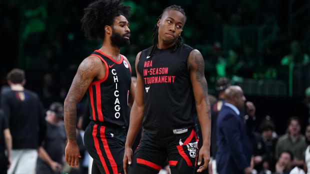  Chicago Bulls guard Ayo Dosunmu (12) and guard Coby White (0) return to the bench during a break in the action against the Boston Celtics in the second half at TD Garden.