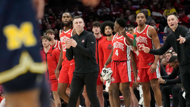 Ohio State Head Coach Jake Diebler applauds the team while heading toward a time out during their NCAA Division I Mens basketball game at Value City Arena.