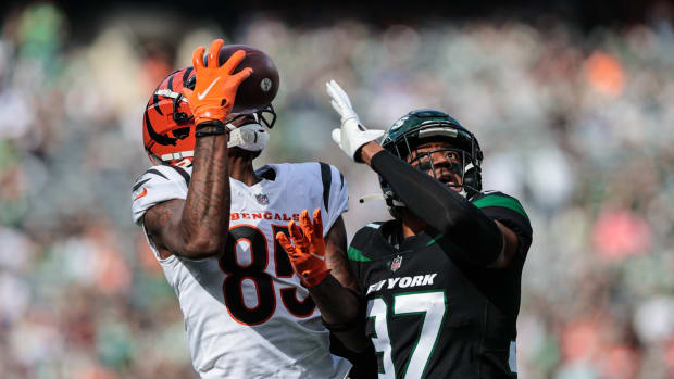 Oct 31, 2021; East Rutherford, New Jersey, USA; Cincinnati Bengals wide receiver Tee Higgins (85) catches the ball as New York Jets cornerback Bryce Hall (37) defends during the first half at MetLife Stadium.