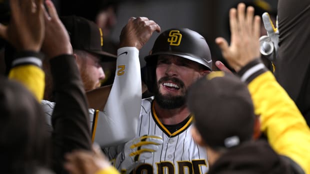 Apr 3, 2023; San Diego, California, USA; San Diego Padres right fielder David Dahl (right) is congratulated in the dugout after hitting a home run during the ninth inning against the Arizona Diamondbacks at Petco Park. Mandatory Credit: Orlando Ramirez-USA TODAY Sports