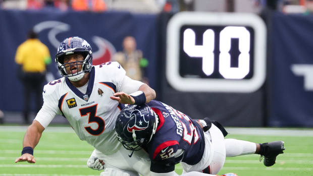 Dec 3, 2023; Houston, Texas, USA;Denver Broncos quarterback Russell Wilson (3) is hit by Houston Texans defensive end Jonathan Greenard (52) after the pass in the second quarter at NRG Stadium. Mandatory Credit: Thomas Shea-USA TODAY Sports