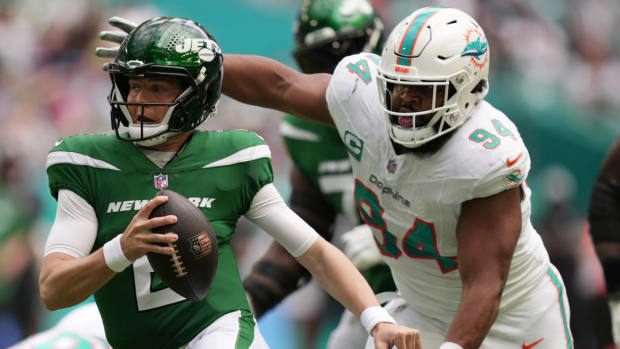 Miami Dolphins defensive tackle Christian Wilkins pursues New York Jets quarterback Zach Wilson.