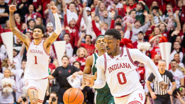 Indiana's Xavier Johnson (0) runs out the clock as Kel'el Ware (1) starts celebrating the victory during the second half of the Indiana versus Michigan State men's basketball game at Simon Skjodt Assembly Hall on Sunday, March 10, 2024.