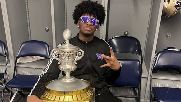 Elishah Jackett poses with the Sugar Bowl trophy in New Orleans.