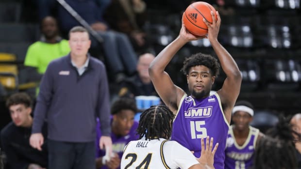James Madison Dukes forward Jaylen Carey (15) looks to pass over Southern Miss Golden Eagles forward Bryson Hall (24) during the second half at Reed Green Coliseum in Hattiesburg, Mississippi, on Jan. 6, 2024.