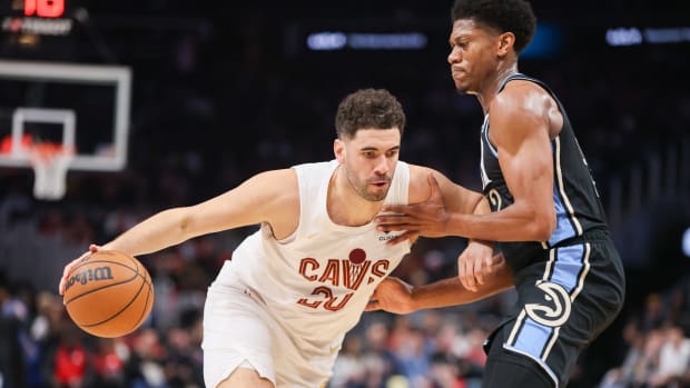 Mar 6, 2024; Atlanta, Georgia, USA; Cleveland Cavaliers forward Georges Niang (20) is defended by Atlanta Hawks forward De'Andre Hunter (12) in the second quarter at State Farm Arena.