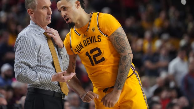 ASU Sun Devils guard Jose Perez (12) talks to head coach Bobby Hurley as they play the UA Wildcats at Desert Financial Arena in Tempe on Feb. 28, 2024. 