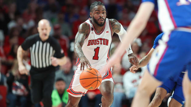 Houston Cougars guard Jamal Shead (1) drives with the ball during the second half against the Kansas Jayhawks at Fertitta Center in Houston, Texas, on March 9, 2024.