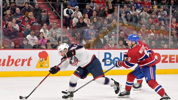 Oct 26, 2023; Montreal, Quebec, CAN; Columbus Blue Jackets forward Justin Danforth (17) shoot on net and Montreal Canadiens defenseman Mike Matheson (8) defends during the third period at the Bell Centre. Mandatory Credit: Eric Bolte-USA TODAY Sports