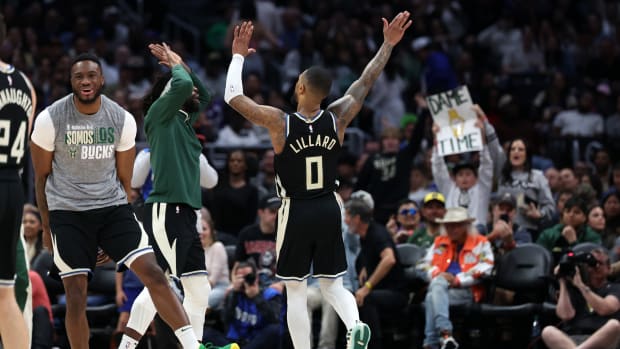 Milwaukee Bucks guard Damian Lillard (0) celebrates with teammates after making a three point basket in the fourth quarter against the Los Angeles Clippers
