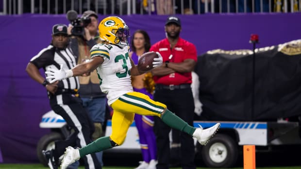 Dec 23, 2019; Minneapolis, Minnesota, USA; Green Bay Packers running back Aaron Jones (33) rushes for a touchdown in the fourth quarter against Minnesota Vikings at U.S. Bank Stadium.