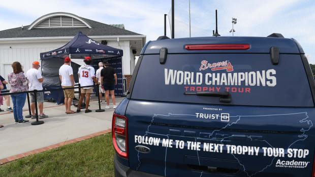 People line up for a photo with the 2021 Braves baseball World Series Championship Trophy at the Anderson University Softball Complex Wednesday July 27, 2022. The trophy is scheduled for 151 stops in the Southeast, commemorating 151 years of Braves baseball. The World Champions Trophy Tour Presented by Truist will travel throughout Braves Country, featuring locations in Georgia, Alabama, Tennessee, Mississippi, South Carolina, and North Carolina, according to Braves officials. Braves Championship Trophy Tour Stops In Anderson
