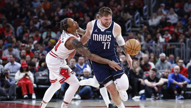 Chicago Bulls forward DeMar DeRozan (11) fouls Dallas Mavericks guard Luka Doncic (77) during the second half at United Center.