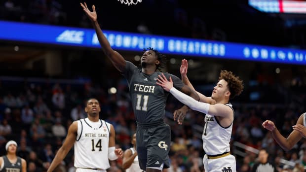 Mar 12, 2024; Washington, D.C., USA; Georgia Tech Yellow Jackets forward Baye Ndongo (11) shoots the ball as Notre Dame Fighting Irish guard Braeden Shrewsberry (11) defends in the first half at Capital One Arena. Mandatory Credit: Geoff Burke-USA TODAY Sports