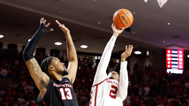 Mar 2, 2024; Norman, Oklahoma, USA; Oklahoma Sooners guard Javian McCollum (2) shoots beside Houston Cougars forward J'Wan Roberts (13) during the second half at Lloyd Noble Center. Mandatory Credit: Alonzo Adams-USA TODAY Sports