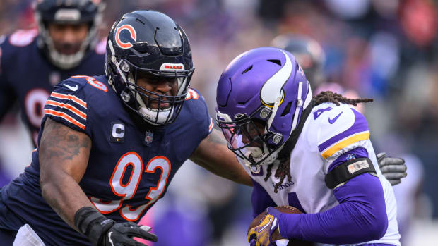 Minnesota Vikings running back Dalvin Cook (4) runs the ball and is tackled by Chicago Bears defensive tackle Justin Jones (93) during the first quarter at Soldier Field.