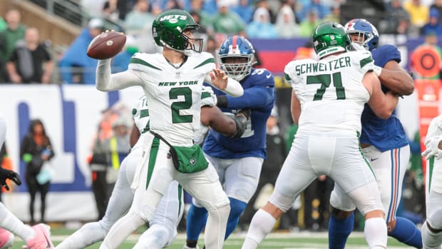Oct 29, 2023; East Rutherford, New Jersey, USA; New York Jets quarterback Zach Wilson (2) throws the ball as New York Giants defensive tackle A'Shawn Robinson (91) pursues during the first half at MetLife Stadium.