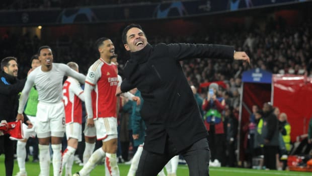 Arsenal manager Mikel Arteta pictured celebrating in front of fans at the Emirates Stadium after his team's penalty-shootout win over Porto in March 2024