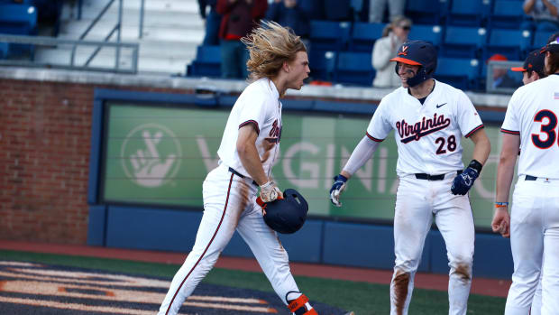 Luke Hanson celebrates with his teammates after hitting an inside-the-park home run during the Virginia baseball game against William & Mary at Disharoon Park.