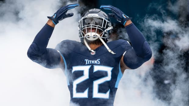 Derrick Henry runs out of a cloud of smoke