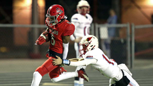 Trystan Haynes is chased by Skyler Moorman during a pick six interception and touchdown as the Carl Albert Titans play Collinsville in State Championship Playoff High School Football on Nov 17, 2023; Midwest City, Oklahoma, USA; at Carl Albert High School. Mandatory Credit: Steve Sisney-The Oklahoman