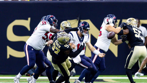 Aug 27, 2023; New Orleans, Louisiana, USA; Houston Texans quarterback Davis Mills (10) is sacked by New Orleans Saints defensive end Malcolm Roach (97) and fumbles the ball during the first half at the Caesars Superdome. Mandatory Credit: Stephen Lew-USA TODAY Sports 