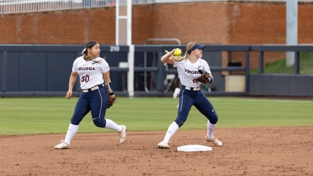 Bella Cabral and Jade Hylton turn a double play during the Virginia softball game against Boston College at Palmer Park.