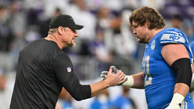 Detroit Lions offensive lineman Graham Glasgow shakes hands with Dan Campbell.