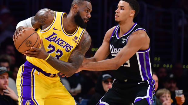 Los Angeles Lakers forward LeBron James (23) moves the ball against Sacramento Kings forward Keegan Murray (13) during the first half at Crypto.com Arena.