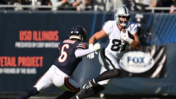 Oct 22, 2023; Chicago, Illinois, USA; Las Vegas Raiders tight end Austin Hooper (81) runs upfield with the ball after a reception as Chicago Bears defensive back Kyler Gordon (6) closes in for the tackle in the fourth quarter at Soldier Field. Mandatory Credit: Jamie Sabau-USA TODAY Sports