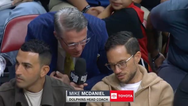 Dolphins coach Mike McDaniel is interviewed at a Heat-Nuggets game.